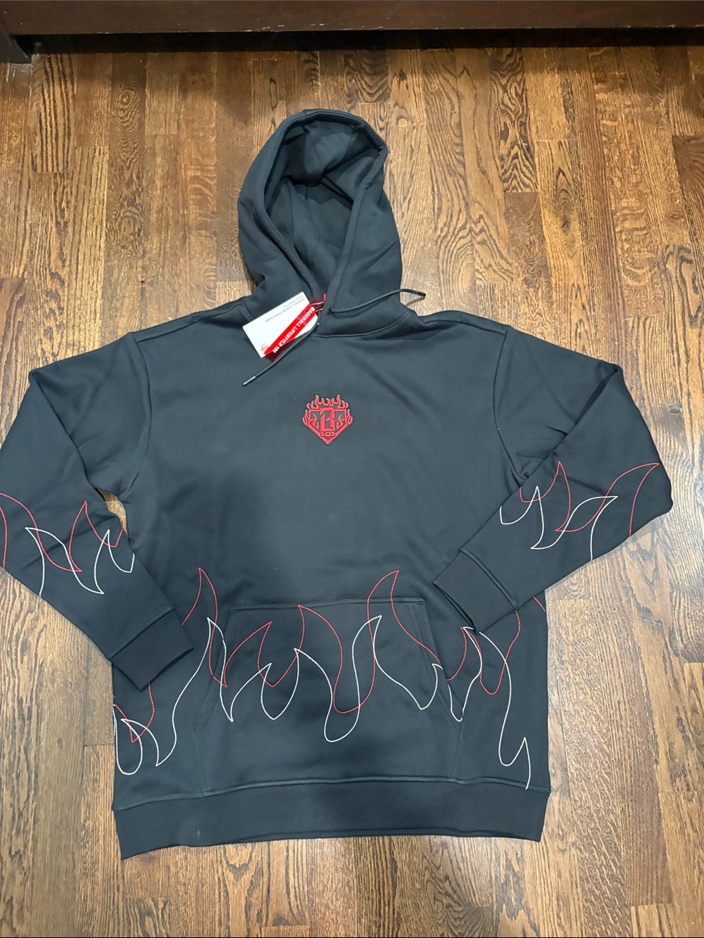 Black Hoodie with Red Flame Accent and Embroidered Crest